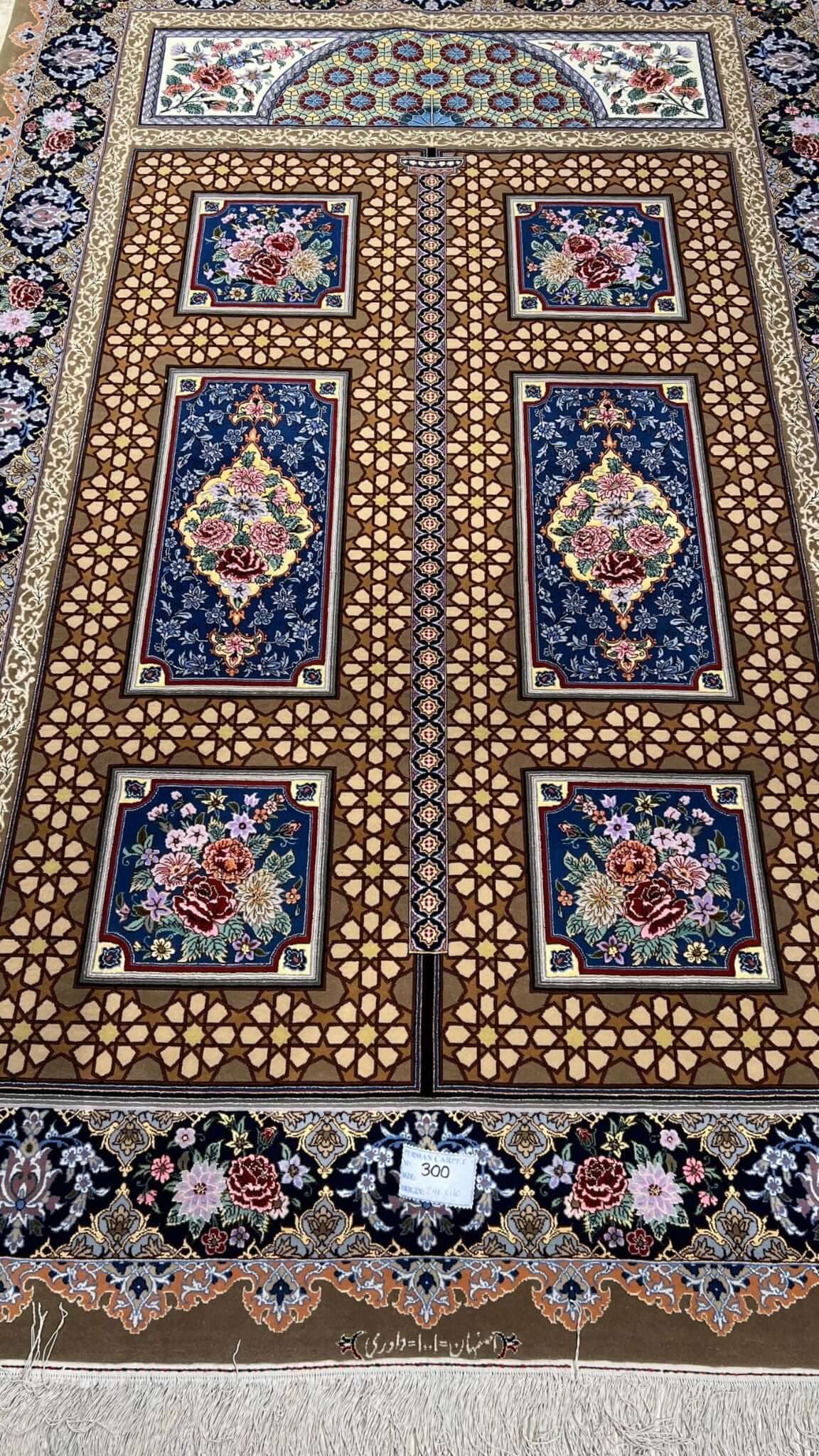 Persian Isfahan rug with geometric and floral designs.